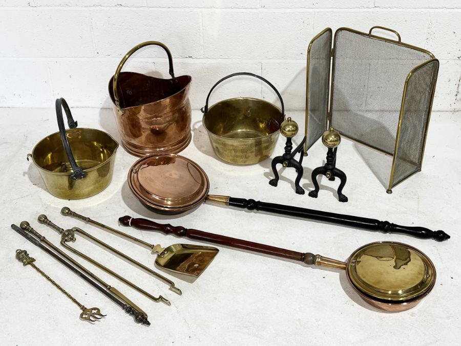 A collection of brass and copper including coal bucket, fire dogs, fire screen etc.