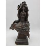 A turn of the century carved wooden bust of a girl on plinth, after Emmanuel Villanis' "Bohemienne"-