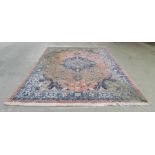 An Eastern pink ground carpet with floral design - approximately 9ft x 11.5ft