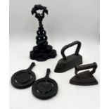 A cast iron doorstop, irons and two Silver Jubilee pan stands
