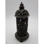 An antique cylindrical Chinese incense burner with pierced decoration consisting of dragons,