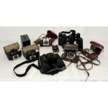 A collection of various vintage cameras and binoculars including Kodak, Bresser, Lieberman & Gortz