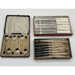 Cased silver plated coffee bean spoons along with two boxed sets of knives