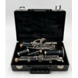 A boxed clarinet by Armstrong with additional reeds