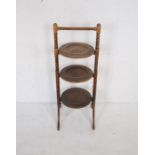 An oak cake stand with bobbin turned supports