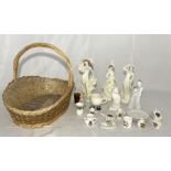 A collection of various ornaments and crested ware with a wicker basket