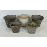 A collection of four vintage galvanised buckets, along with one enamelled bucket