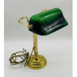 A vintage banker's lamp with green shade