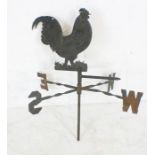 A vintage weather vane in the form of a cockerel