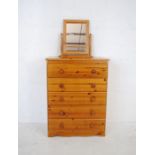 A modern pine chest of five drawers along with a dressing table mirror - length 75cm, depth 43cm,