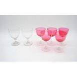 Two glass rummers along with a set of five cranberry glasses