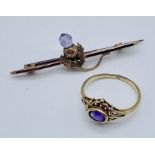 A 9ct gold ring set with an amethyst along with a 9ct brooch in the form of a thistle with pale