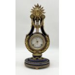 A cobalt blue and gilt Marie Antoinette 18th century style lyre mantle clock by Franklin Mint for