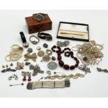 A collection of costume jewellery including vintage cherry amber coloured beads, watches, Pierre