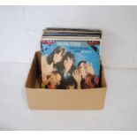 A quantity of 12" vinyl records including The Beatles, The Rolling Stones, Cat Stevens, Simon and