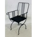 A wrought iron black painted garden chair