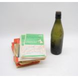 A Mitchell Toms & Co of Chard glass bottle along with a collection of local ordnance survey maps -