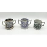 An antique loving cup with transfer printed decoration and the interior moulded with newt/lizard and