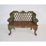 A Victorian weathered cast iron bench with ornate detailing - length 110cm