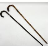 Two silver collared walking sticks both with inscriptions, one dated 24.7.37 the other presented