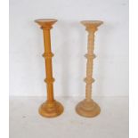 A wooden barley twist torchiere along with one other - height 101cm