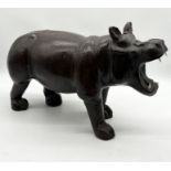 A Liberty style leather Hippopotamus with glass eyes and plastic tusks - overall height 40cm x