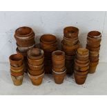 A collection of various sized terracotta pots