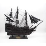 A wooden model ghost ship of 'The Flying Dutchman' ghost ship on stand - length 61cm, height 51cm