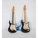 A Peavey Raptor EXP electric guitar along with a Behringer Stratocaster electric guitar (A/F)