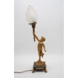 An ormolu lamp on marble base in the form of a putti holding aloft a torch - total height 56cm