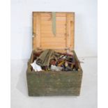 A vintage trunk containing various tools including hammers, wrenches etc.