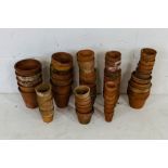 A collection of various sized terracotta pots