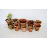 A quantity of terracotta garden pots including a strawberry pot