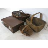Three vintage wicker baskets plus a vintage leather suitcase.