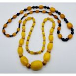 Two vintage amber necklaces, each with wooden beads interspacing the graduated amber beads