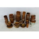 A collection of various sized terracotta pots etc
