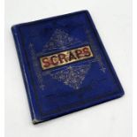 A Victorian book of scraps in blue cloth binding with gilt decoration