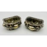 A pair of ornate hallmarked silver salts