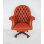 A leather button-back swivel office chair - one brass foot mount loose but present