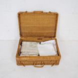 A wicker basket containing various linen