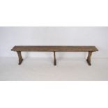 A weathered wooden bench - length 221cm, height 45cm