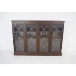 A stained pine display cabinet with leaded light glazing - length 176cm, depth 27cm, height 124cm