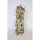 A weathered Balinese lava stone statue of a deity - two pieces loose but present, A/F - height