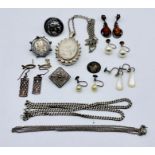 A small collection of silver jewellery including Victorian locket, brooches etc.