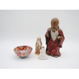 Two ceramic Oriental figures of deities along with an alabaster Buddha and an Imari bowl