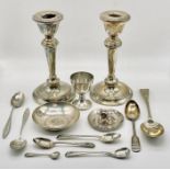 A pair of hallmarked silver candlesticks (A/F) along with 8 silver and continental silvers spoons,