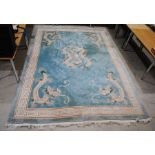 A Chinese blue ground carpet depicting dragons - 394cm x 274cm