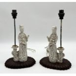 A pair of Chinese blanc de chine lamps on wooden bases - some losses as shown