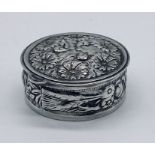 A 925 silver pill box with pressed floral decoration