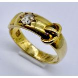 An 18ct gold buckle ring set with a diamond of approx. 0.25ct, weight 4.9g